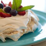 Fluffy Aquafaba Pavlova Topped with Coconut Whipped Cream
